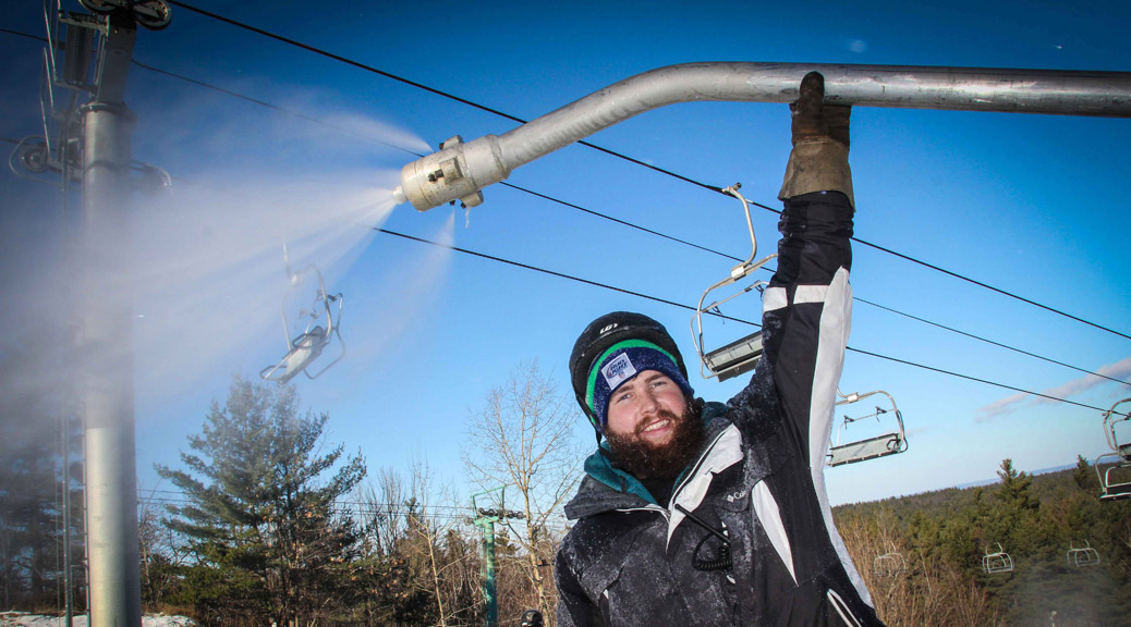 Alex Weir adjusts the snow gun near the top of a trail at Mount Pakenham. Hill workers have been busy preparing for this weekend's opening of the ski season. (Photo by Barry Gray/For StittsvilleCentral.ca)