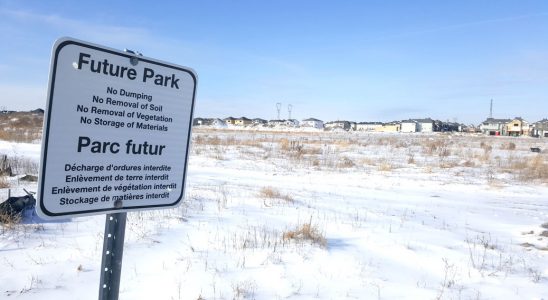 Looking west towards the future Blackstone Community Park. This sign is close to the Monahan Drain, part of the neighbourhood's stormwater infrastructure. Photo by Glen Gower.