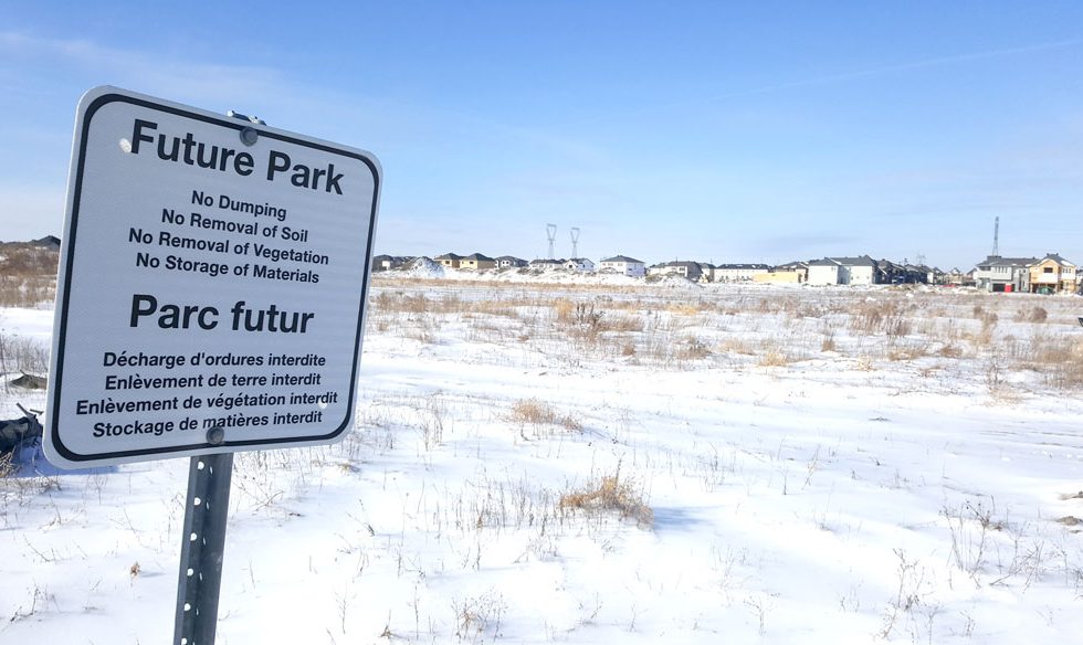 Looking west towards the future Blackstone Community Park. This sign is close to the Monahan Drain, part of the neighbourhood's stormwater infrastructure. Photo by Glen Gower.