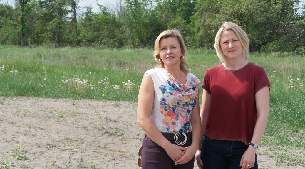 Jennifer Smith (left) and Jenny Guth have been two of the most active parents involved in the push for a public high school. They're standing on one of the possible sites for the new school, at the south west corner of Robert Grant and Cope.