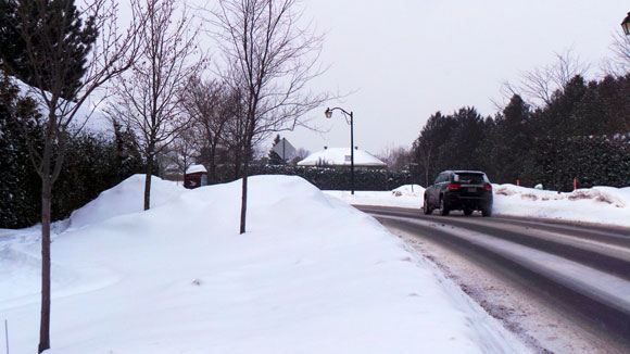 The summer pathway is buried under piles of snow during the winter.